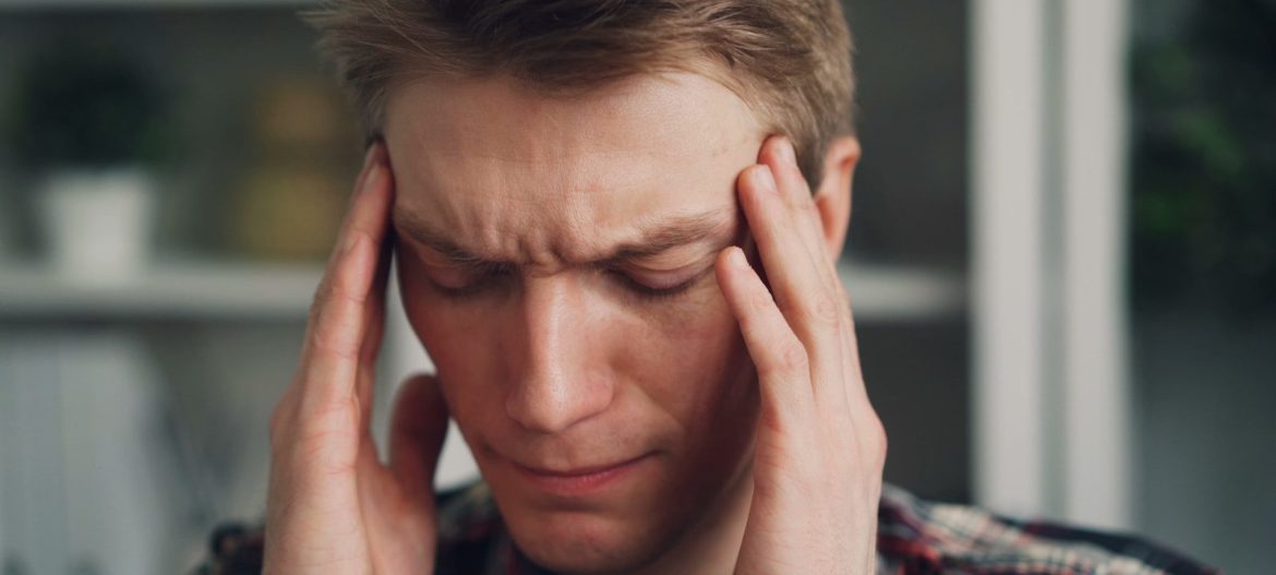 a man holding his hands to his ears